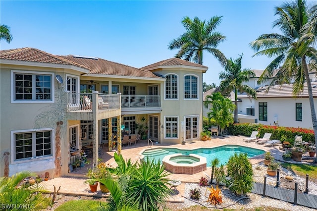 view of pool with an in ground hot tub and a patio area