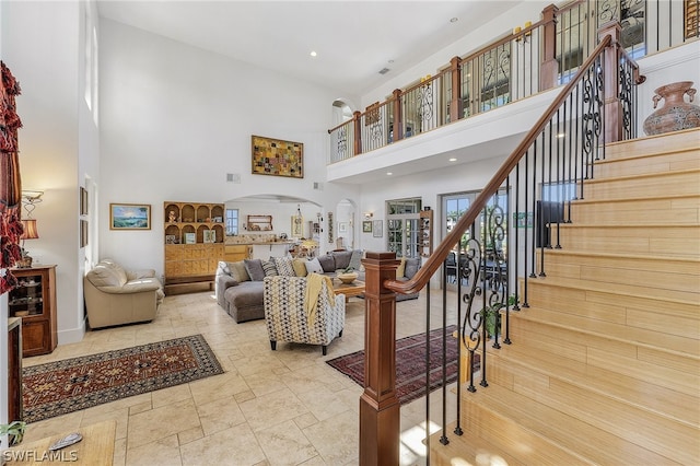 tiled living room featuring a high ceiling