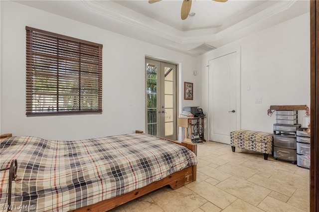 bedroom featuring ceiling fan, a tray ceiling, french doors, light tile floors, and access to exterior