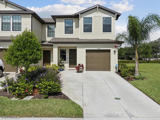 view of front facade with a front yard and a garage