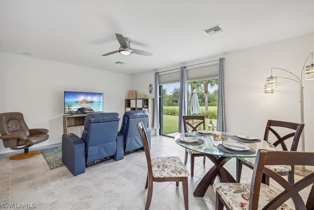 tiled dining area featuring ceiling fan