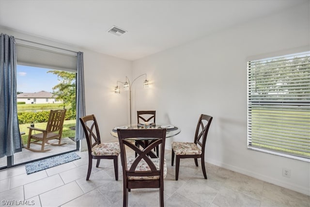 dining area with plenty of natural light and light tile flooring