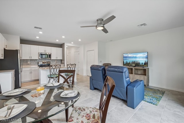 dining space with light tile flooring and ceiling fan