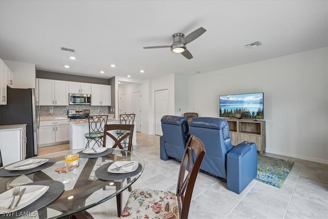 dining room featuring light tile patterned flooring, visible vents, recessed lighting, and a ceiling fan