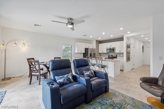 living room with light tile patterned flooring, baseboards, visible vents, ceiling fan, and recessed lighting