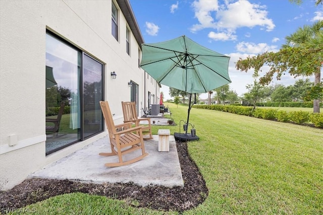 view of yard with central air condition unit and a patio area