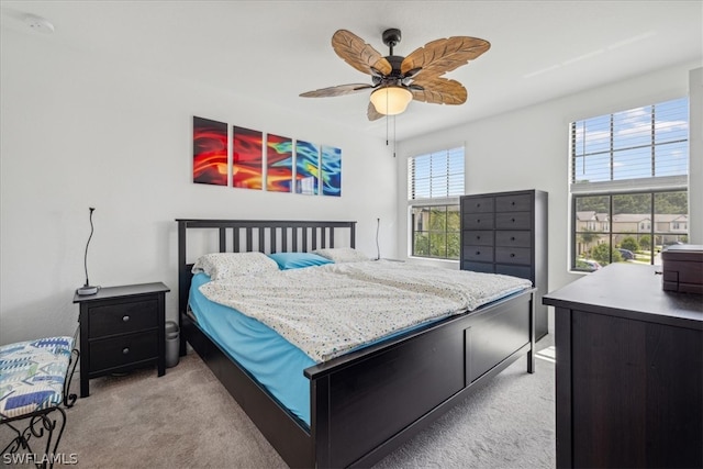 carpeted bedroom featuring ceiling fan