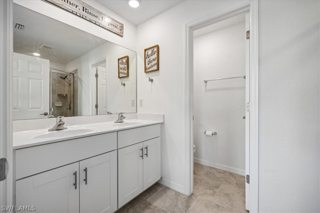 bathroom with vanity with extensive cabinet space, dual sinks, toilet, tile flooring, and an enclosed shower