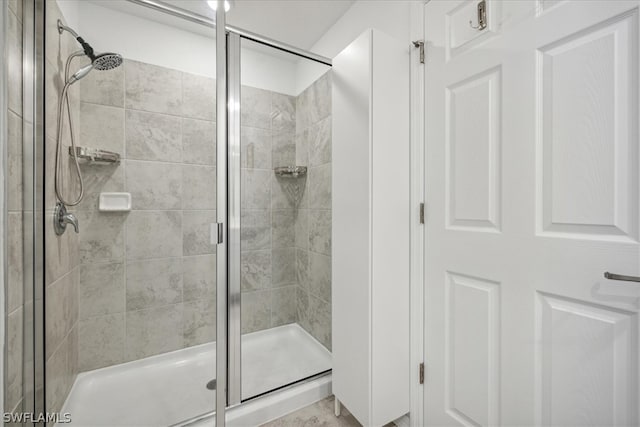 bathroom featuring a shower with shower door