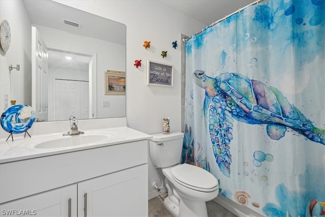 bathroom featuring tile floors, toilet, and oversized vanity