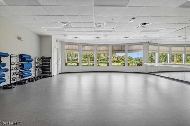 gym with plenty of natural light, visible vents, and a paneled ceiling