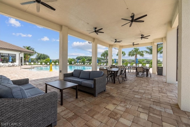 view of patio featuring a community pool, ceiling fan, and an outdoor hangout area