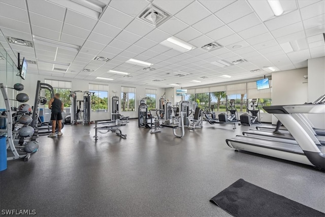 gym with a paneled ceiling