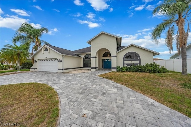 view of front facade featuring a front yard and a garage