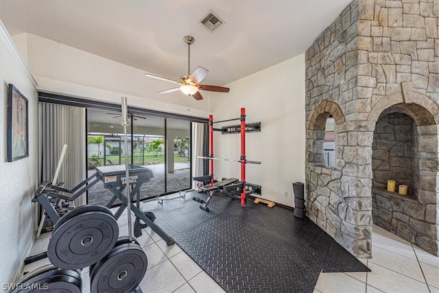 workout room featuring light tile patterned floors and ceiling fan