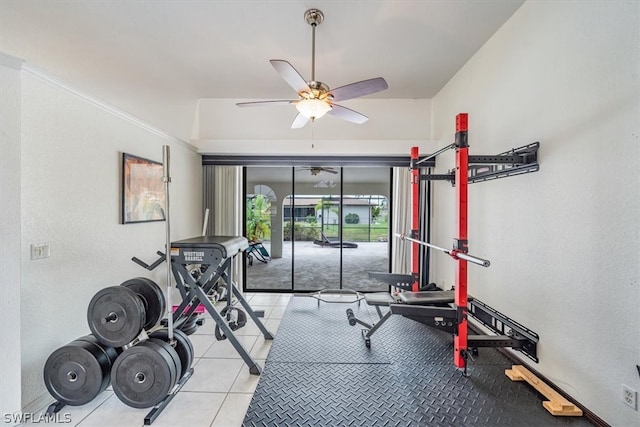 exercise room with ceiling fan and light tile patterned flooring