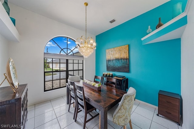 tiled dining area featuring a chandelier