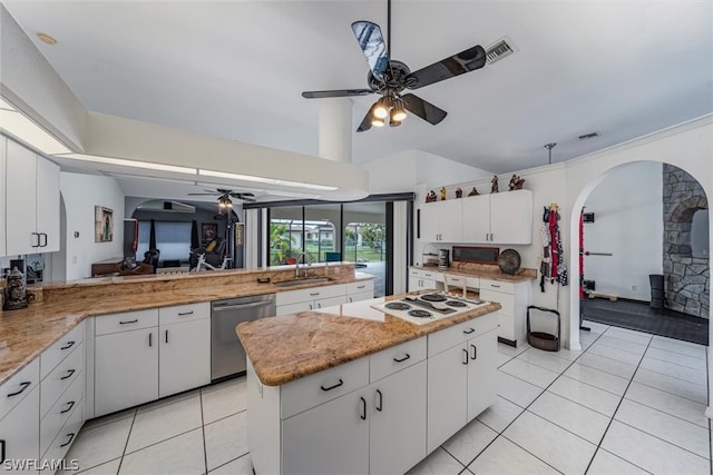 kitchen with dishwasher, sink, kitchen peninsula, light tile patterned flooring, and white cabinetry