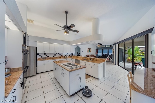 kitchen featuring backsplash, white cabinetry, a kitchen island, and sink