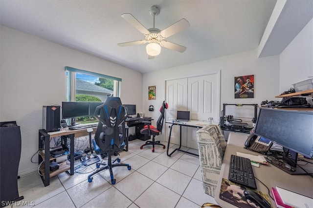 tiled office featuring ceiling fan and a textured ceiling