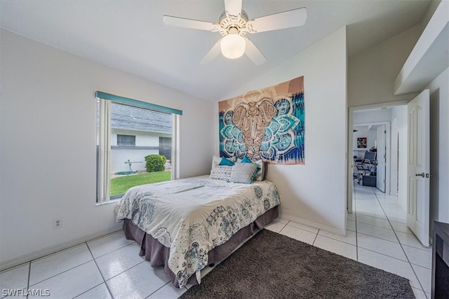 bedroom with light tile patterned floors, vaulted ceiling, and ceiling fan