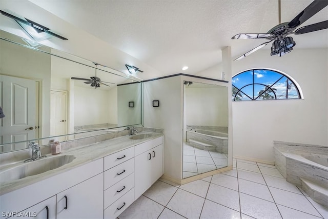 bathroom featuring a skylight, tile patterned flooring, a bath, a textured ceiling, and vanity