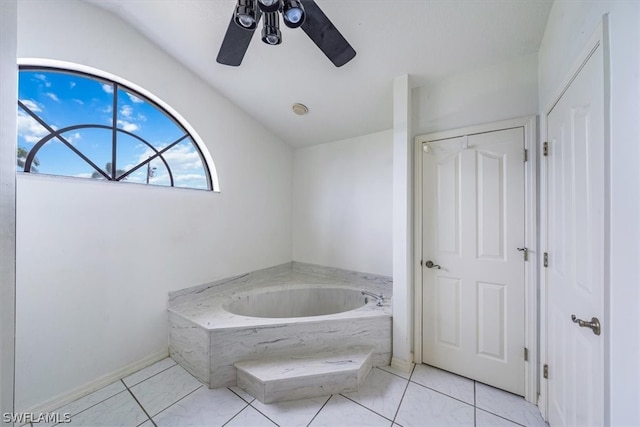 bathroom featuring tile patterned flooring, vaulted ceiling, ceiling fan, and a tub