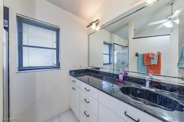 bathroom featuring ceiling fan, lofted ceiling, a shower with door, and a wealth of natural light