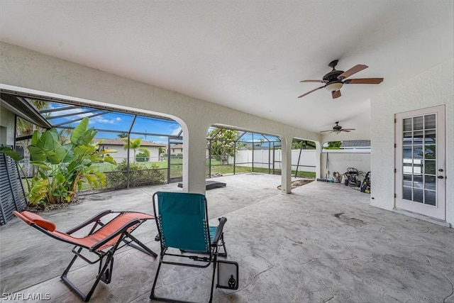 view of patio with ceiling fan and a lanai