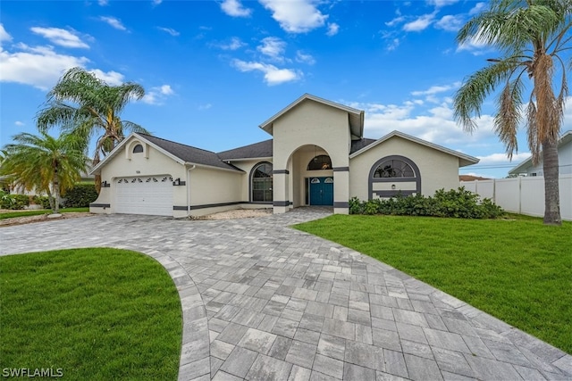 view of front of house with a garage and a front lawn