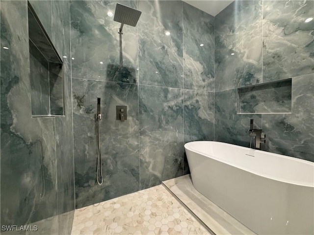 bathroom featuring plus walk in shower and tile walls