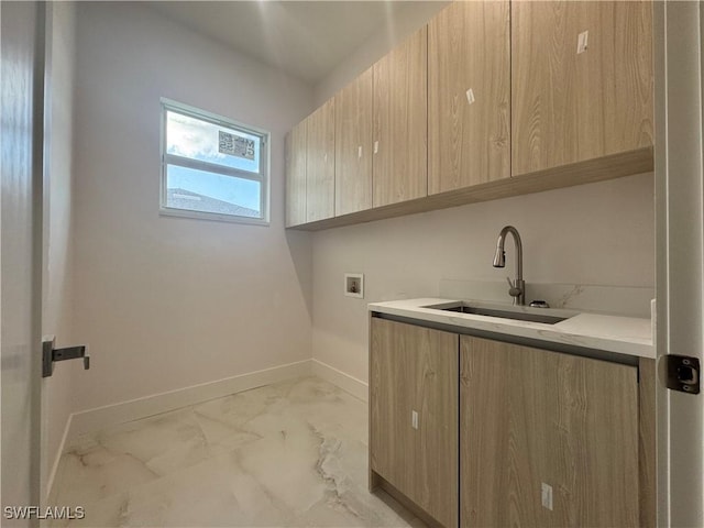 clothes washing area with washer hookup, sink, and cabinets