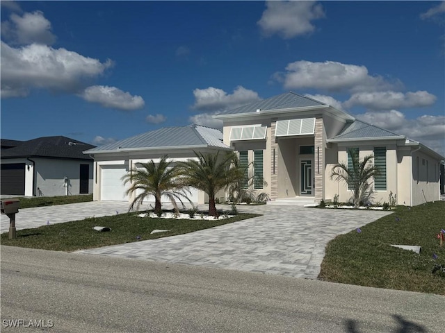 view of front of property featuring a garage and a front lawn