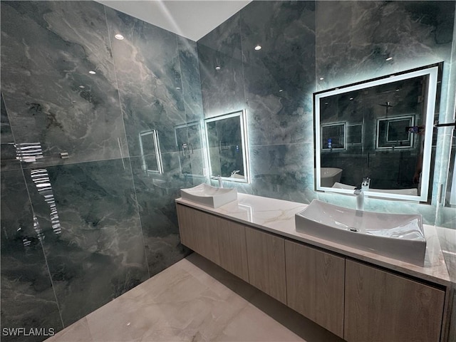 bathroom featuring tile walls and vanity