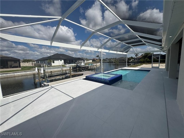 view of swimming pool with a patio, an in ground hot tub, a water view, and glass enclosure