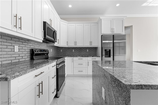 kitchen with dark stone countertops, white cabinetry, stainless steel appliances, crown molding, and tasteful backsplash