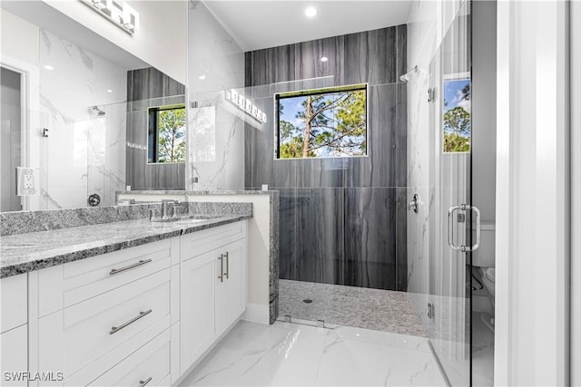 bathroom featuring an enclosed shower and vanity