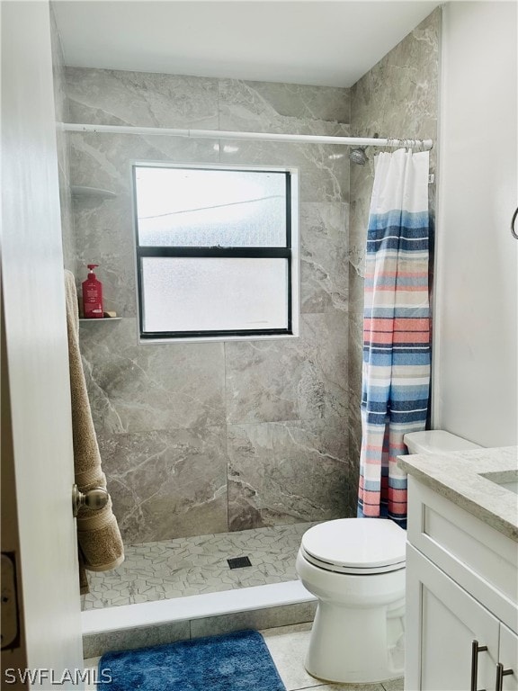 bathroom with walk in shower, vanity, toilet, and tile patterned flooring