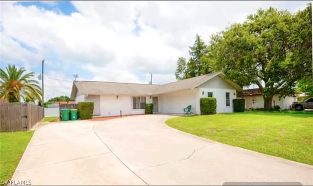 ranch-style home with a front lawn