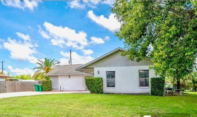 rear view of house with a yard and a garage