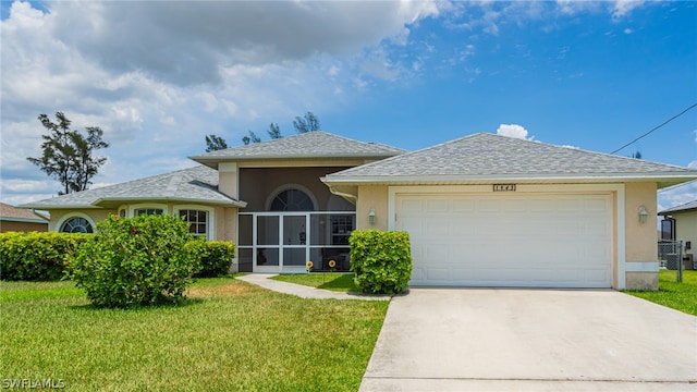 view of front of property with a front lawn, a garage, and a sunroom