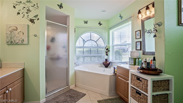 bathroom featuring vanity, independent shower and bath, and tile patterned flooring