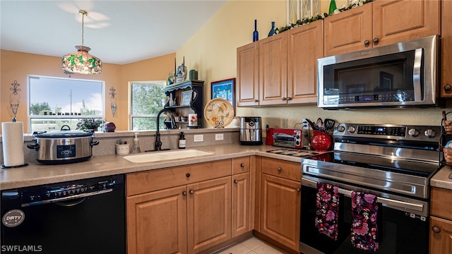 kitchen with lofted ceiling, stainless steel appliances, sink, and light tile patterned floors