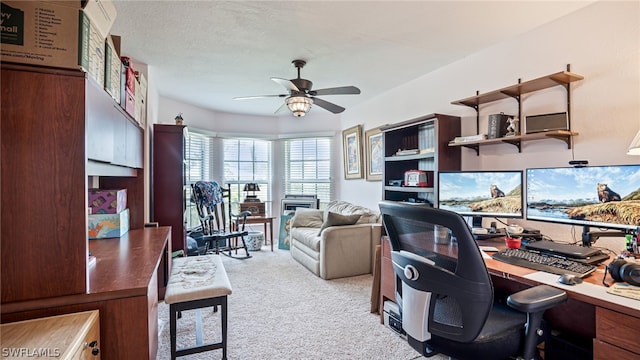 office featuring light carpet, a textured ceiling, and ceiling fan