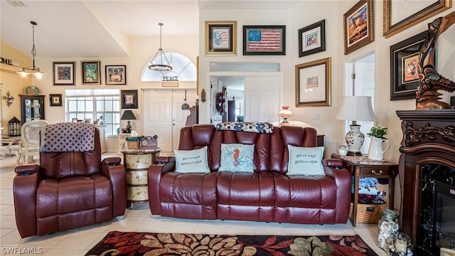 living room featuring a notable chandelier, high vaulted ceiling, and light tile patterned floors