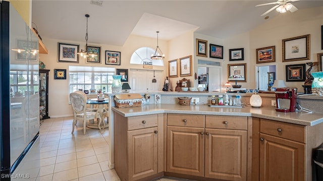 kitchen featuring hanging light fixtures, ceiling fan with notable chandelier, and light tile patterned floors