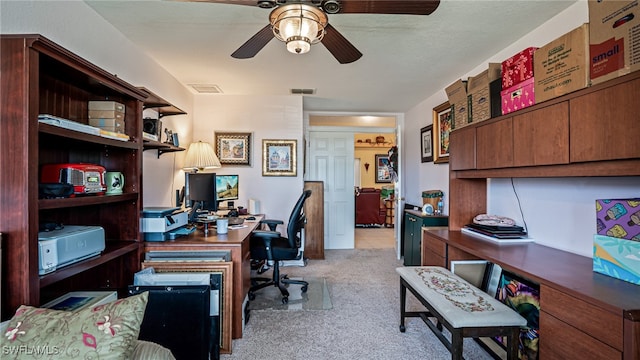 office space with ceiling fan and light colored carpet