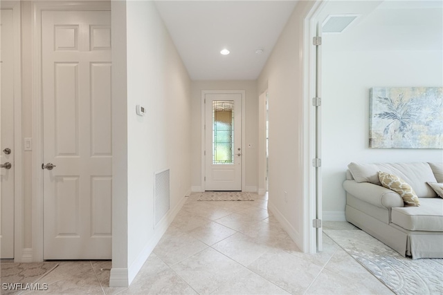 hall with light tile patterned flooring