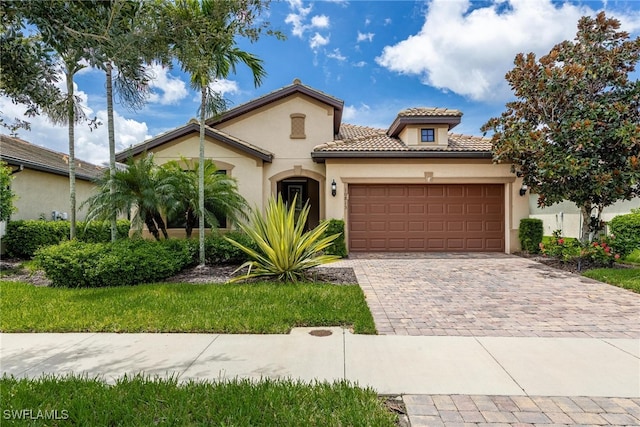 mediterranean / spanish-style home with a garage