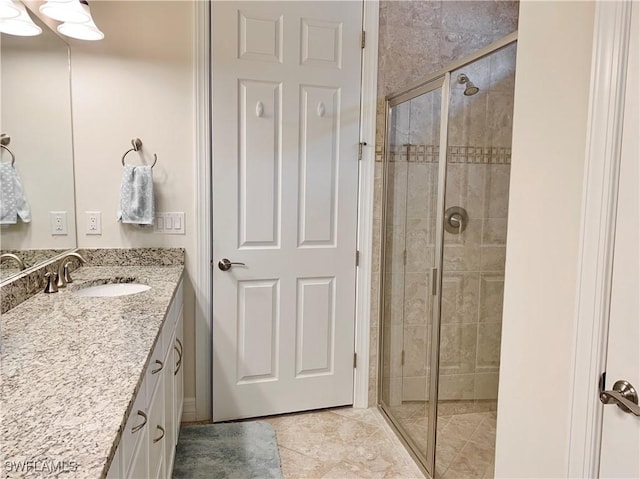 bathroom with tile patterned floors, vanity, and walk in shower